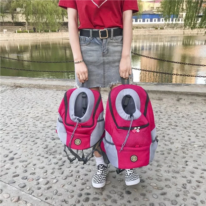 Portable Pet Backpack Carrier for small dogs in pink being held near a river.