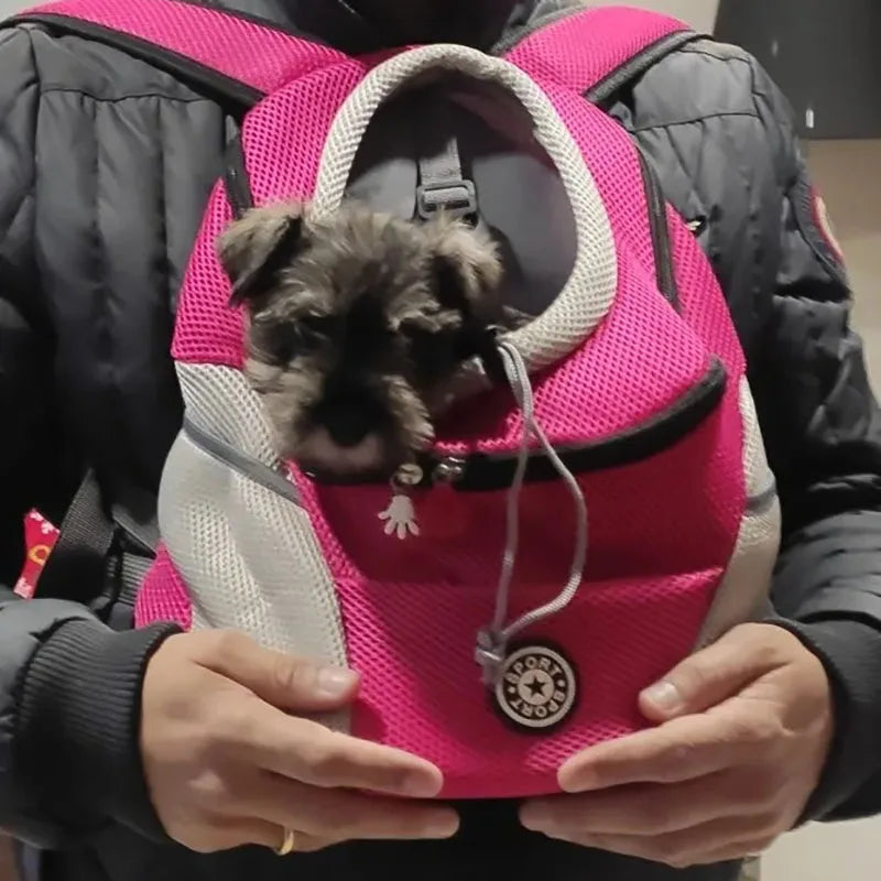Portable Pet Backpack Carrier for small dogs, featuring a pet safely nestled inside a vibrant pink carrier.